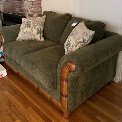Green upholstered loveseat, with wooden accent