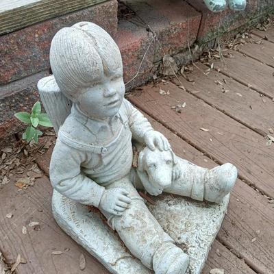 SIGNED CEMENT BOY WITH A DOG YARD ART