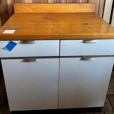 White metal cabinet with wooden countertop