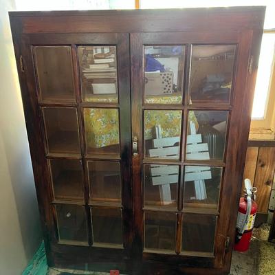 Dark wood cabinet with glass doors
