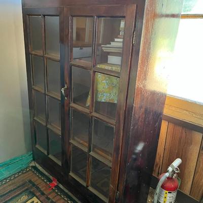 Dark wood cabinet with glass doors