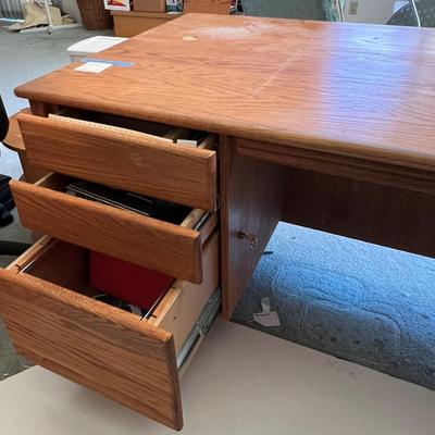 Oak wood desk with three drawers and keyboard tray