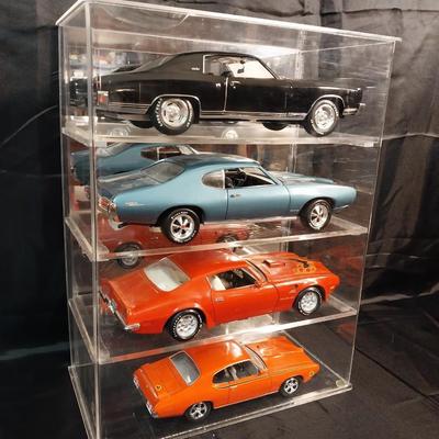 4 SCALED DIE-CAST MODELS IN A DISPLAY CASE