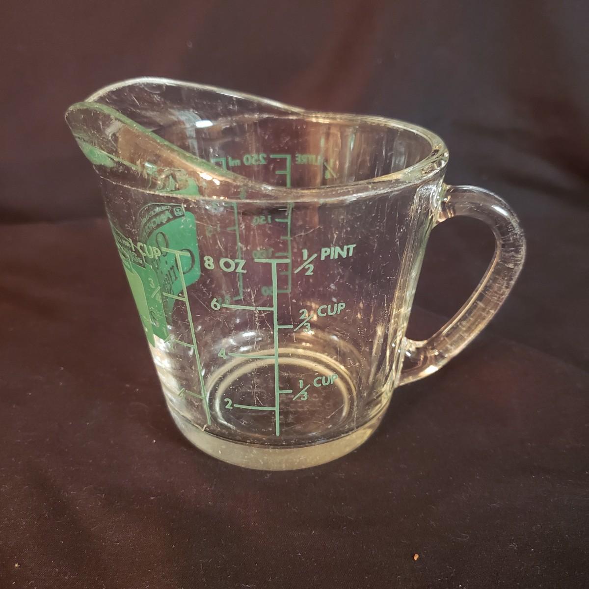 Sold at Auction: 2- PYREX GLASS MEASURING CUPS