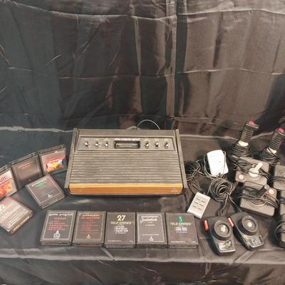 VINTAGE ATARI GAME CONSOLE WITH CONTROLS AND GAMES