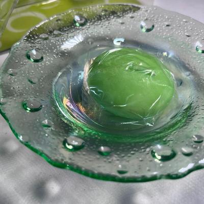 PAIR OF LIGHT GREEN GLASS TEA LIGHT HOLDERS WITH CANDLES