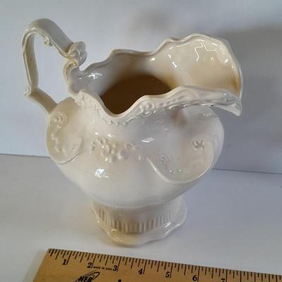 Pitcher with bowl and collectible pig figures