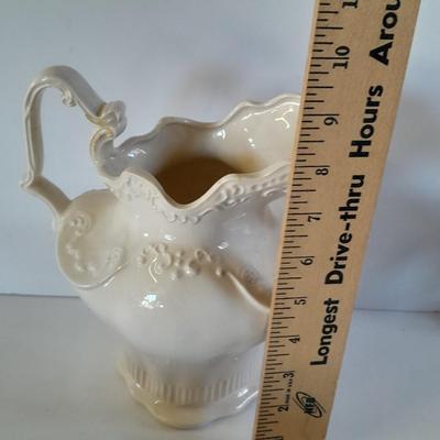 Pitcher with bowl and collectible pig figures
