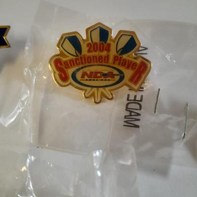 Assortment of hat pins - New York, stamp replica's and more