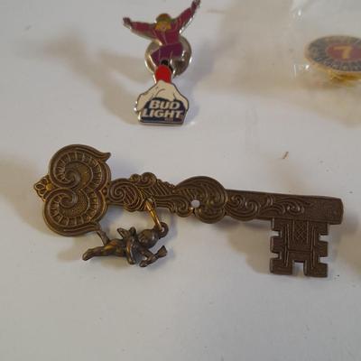 Assortment of hat pins - New York, stamp replica's and more
