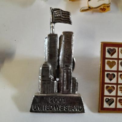 Assortment of hat pins - New York, stamp replica's and more