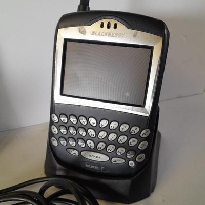 Two older Blackberry Phones with accessories