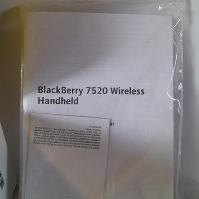 Two older Blackberry Phones with accessories