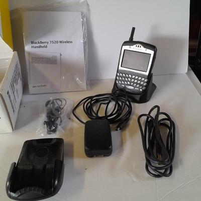 Two older Blackberry Phones with accessories