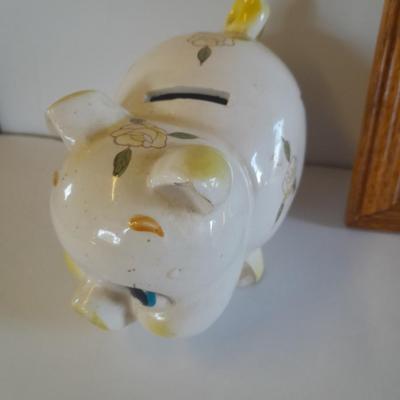 Framed wall art, vase with faux flowers, and pig figures -- piggy bank
