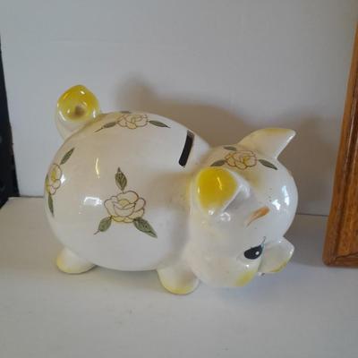 Framed wall art, vase with faux flowers, and pig figures -- piggy bank