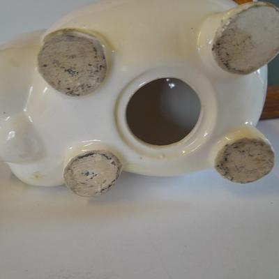 Framed wall art, vase with faux flowers, and pig figures -- piggy bank