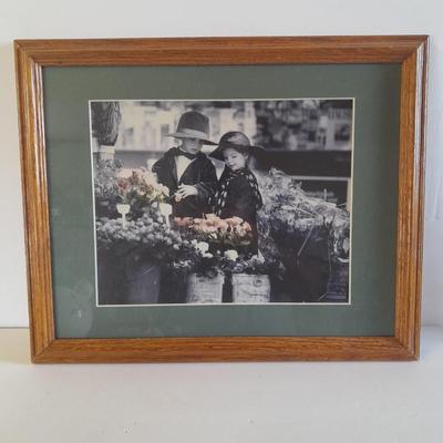 Framed wall art, vase with faux flowers, and pig figures -- piggy bank