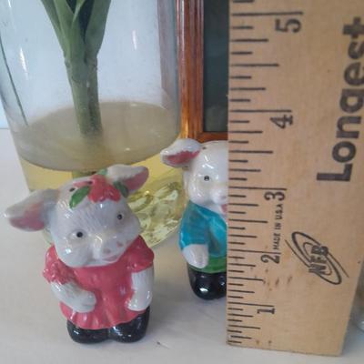 Framed wall art, vase with faux flowers, and pig figures -- piggy bank