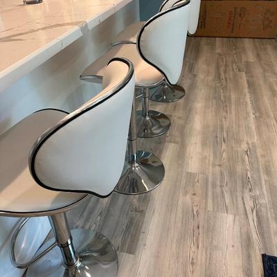 Four white leather and chrome stools