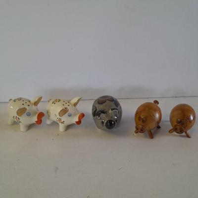 Five small pig figures, wood pigs, floral salt & pepper, and a pottery pig