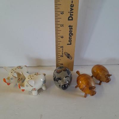 Five small pig figures, wood pigs, floral salt & pepper, and a pottery pig