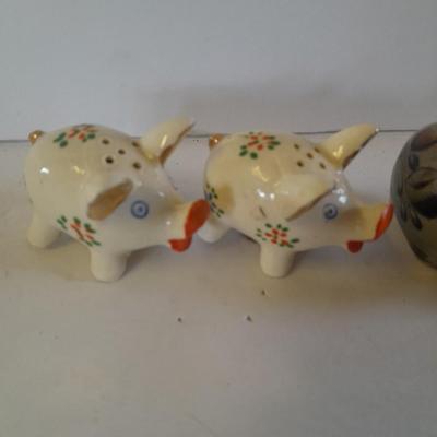 Five small pig figures, wood pigs, floral salt & pepper, and a pottery pig