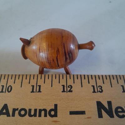 Five small pig figures, wood pigs, floral salt & pepper, and a pottery pig