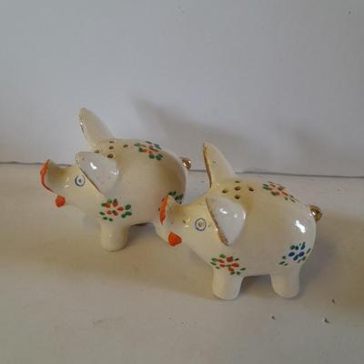Five small pig figures, wood pigs, floral salt & pepper, and a pottery pig