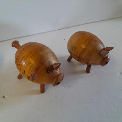 Five small pig figures, wood pigs, floral salt & pepper, and a pottery pig