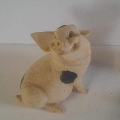 Collection of four Black and white pig figures