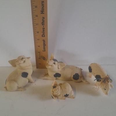 Collection of four Black and white pig figures