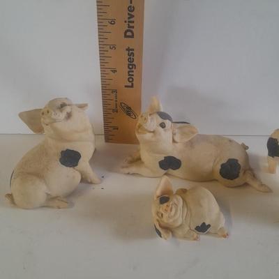 Collection of four Black and white pig figures