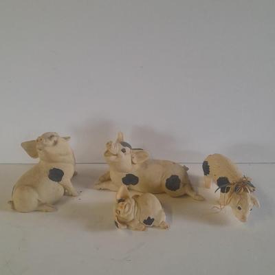 Collection of four Black and white pig figures