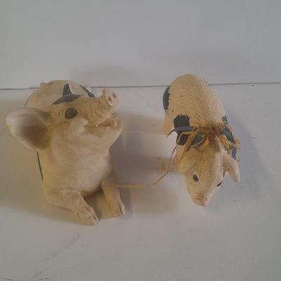 Collection of four Black and white pig figures