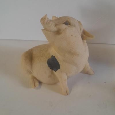 Collection of four Black and white pig figures
