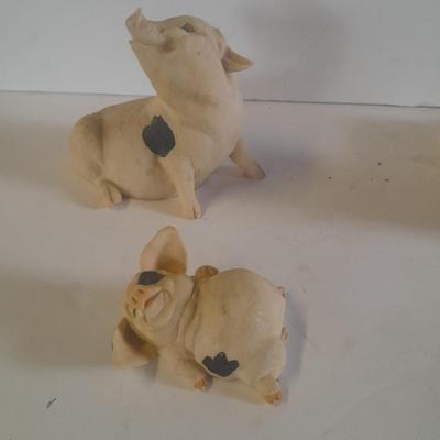 Collection of four Black and white pig figures