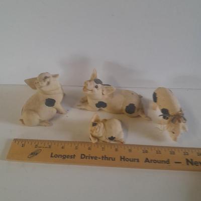 Collection of four Black and white pig figures
