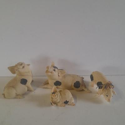 Collection of four Black and white pig figures