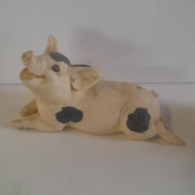 Collection of four Black and white pig figures