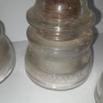 Four clear glass Hemingray Insulators