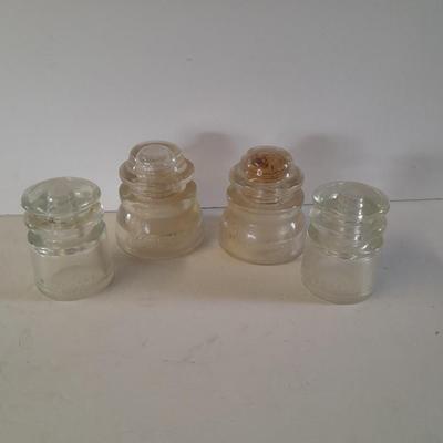 Four clear glass Hemingray Insulators