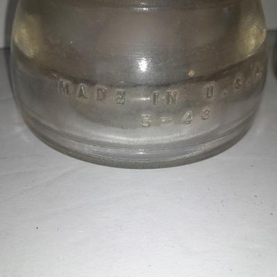 Four clear glass Hemingray Insulators