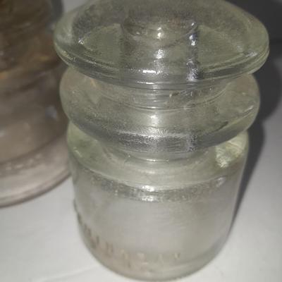 Four clear glass Hemingray Insulators