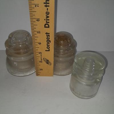 Four clear glass Hemingray Insulators