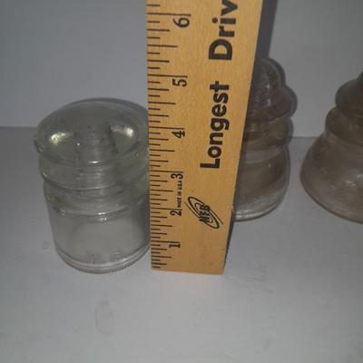 Four clear glass Hemingray Insulators