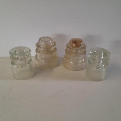 Four clear glass Hemingray Insulators