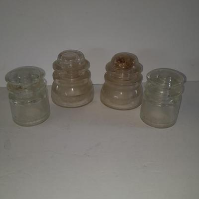 Four clear glass Hemingray Insulators