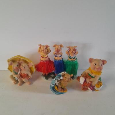 Hear no, See no, Speak no Hula dancer pigs, with other pigs from the beach