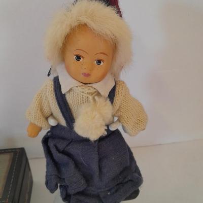 Two collectible dolls with stands, small wooden decorative box and some jewelry